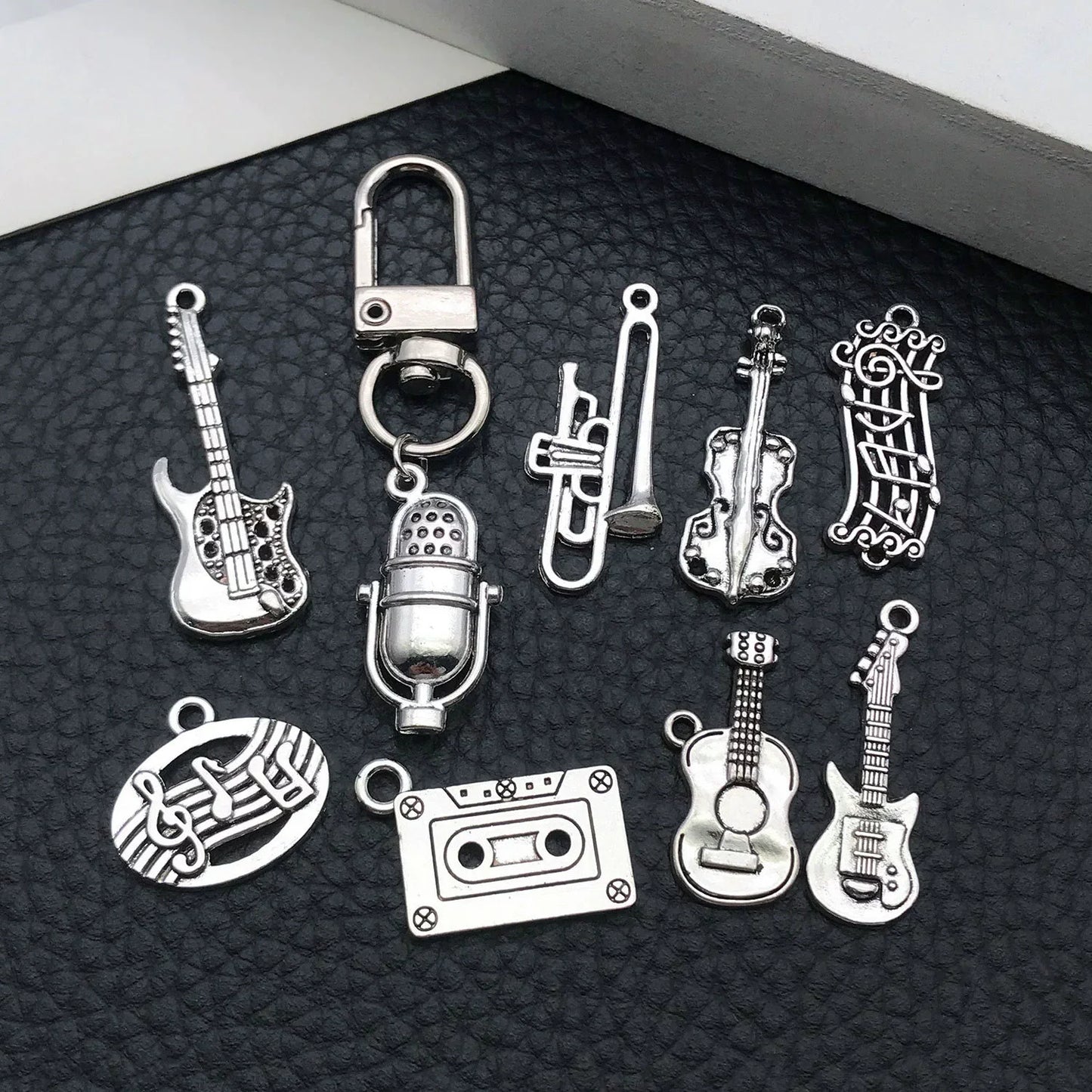 The 10 silver music instrument charms neatly packaged and ready for DIY crafting or gifting.