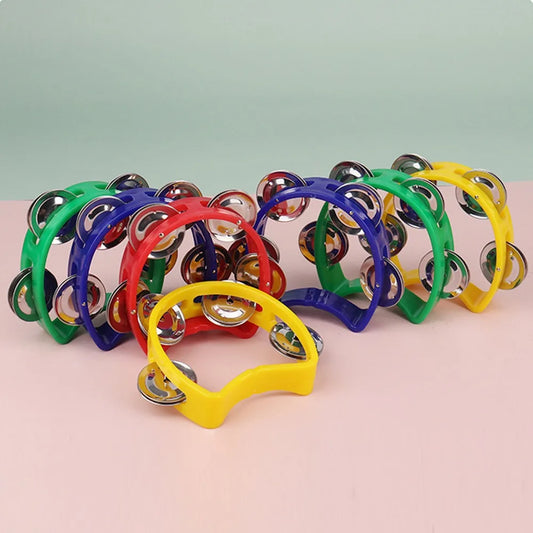 Front view of a plastic hand tambourine showing its circular frame and jingling discs.
