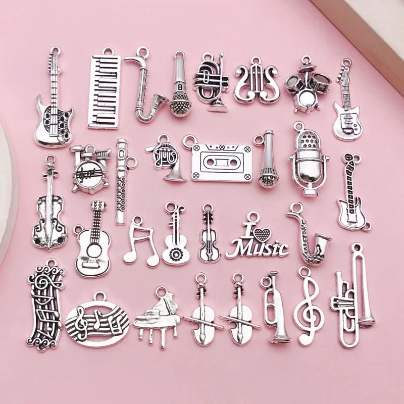 A 10-piece silver music instrument charm set including guitar, mic, and musical note designs.