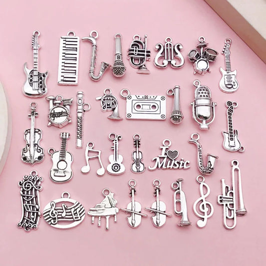 A 10-piece silver music instrument charm set including guitar, mic, and musical note designs.